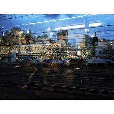 Commuters are reflected thru the window of metro in Tokyo