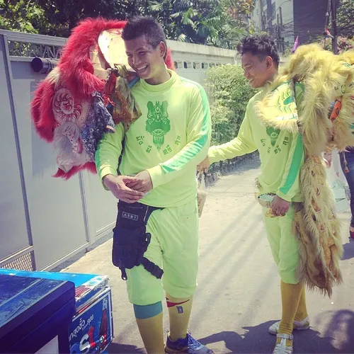 Traditional Chinese lion dancers wait in line for their T