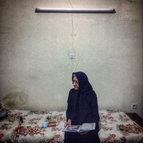 Portrait of my grandmother while reading Quran in her bed