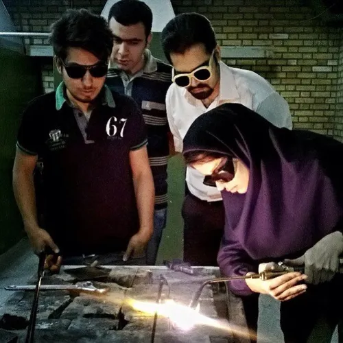 A student practices gas welding at a workshop in Islamic 