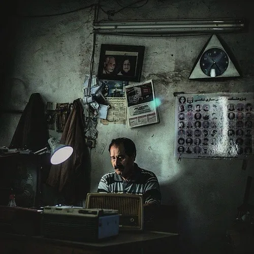 A TV and radio repairman works at his shop. Mazandaran, I