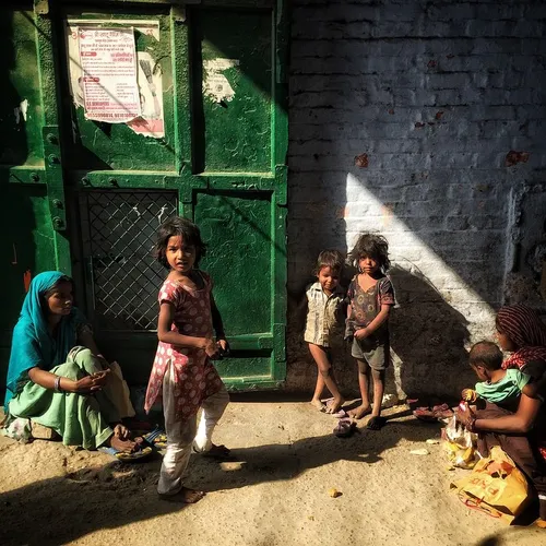 Homeless women seen with their children outside a temple 