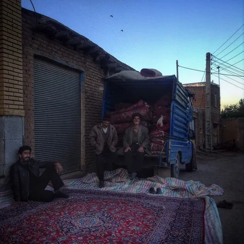 A group of villagers selling Iranian traditional carpet i