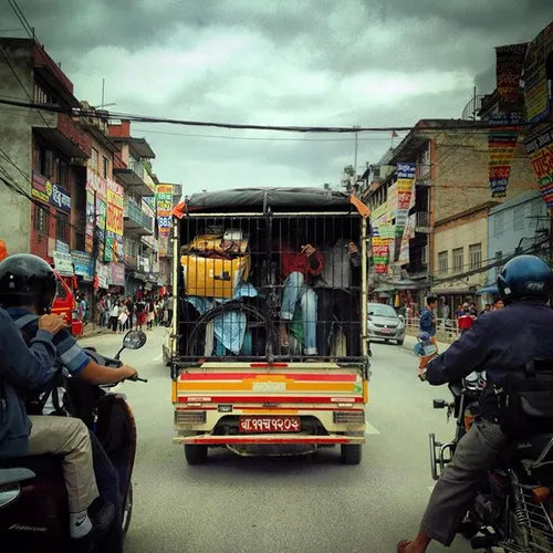 Nepalese workers sits inside a vehicle go to their daily 