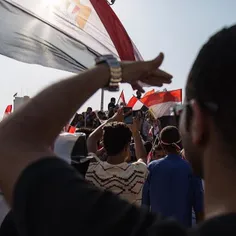 A man watches as people sing, dance and celebrate the ope