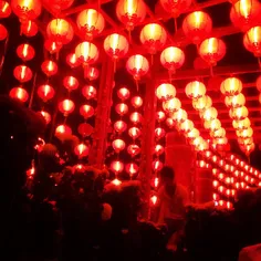 Temple worker collated flowers underneath traditional Chi