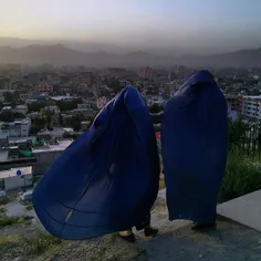 A family walked up and over a hill in central Kabul befor