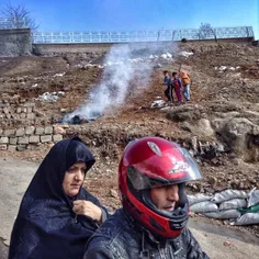 A group of children playing around the fire which they ma