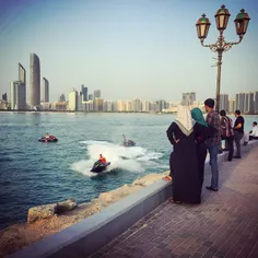 Jet skiers entertain people along the Abu Dhabi Corniche,