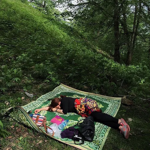 A woman takes a nap at a forest in MahmoodAbad, Mazandara