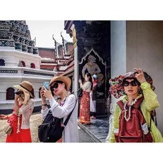 Chinese tourists take photos at Bangkok's Grand Palace. P
