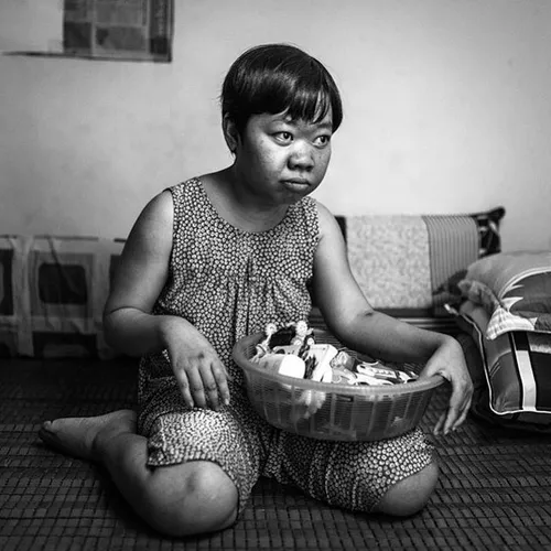 Phuong Quynh, 26, in portrait at her home in BienHoa City