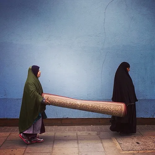 Two women carry a rug near Elephant & Castle in London. P