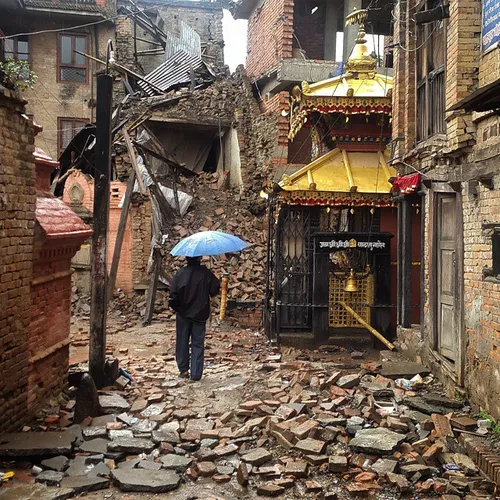 A man walks by the destruction in the district of Bhaktap