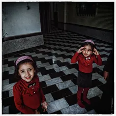 Twin sisters playing in a mosque in Arateh, Mazandaran Pr