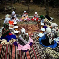 Women in traditional dresses get together to read the Qur