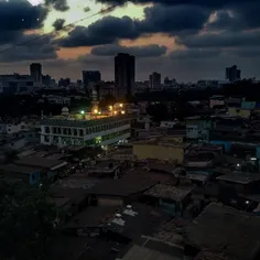 The lights from a mosque shine at dusk in the Malad East 