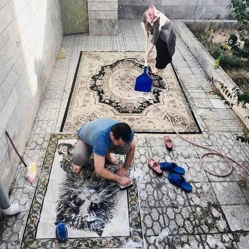 A couple cleaning carpets at the houseyard. Quchan, Razav