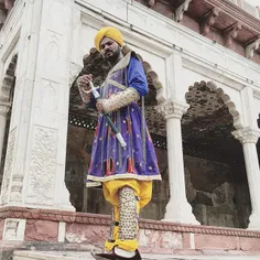 A man in costume poses as one of the guards from the reig