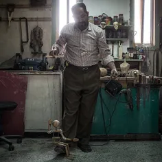 Mr. Youssif, a 42-year-old puppet maker, plays with an un