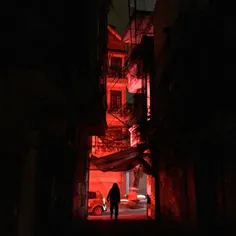 A woman walks home late on a small alley in centre area o