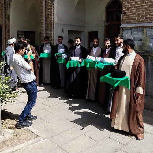 A photographer takes a photo of Muslim clergymen who are 