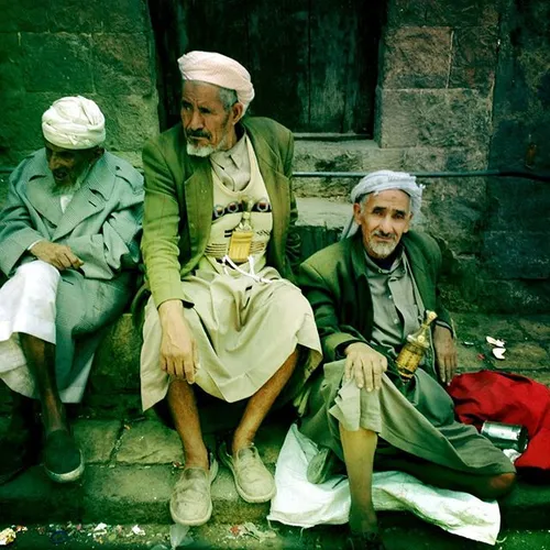 Old Yemeni men sit around inside the old city of Sanaa, M