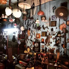 Old stuffs hang up on the wall of an antiques shop in Le 