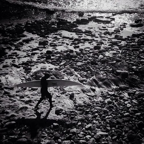 A surfer heads into the water at Cowaramup Bay in Graceto