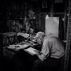An elderly man reads Quran at his shop in #Zanjan Bazaar.
