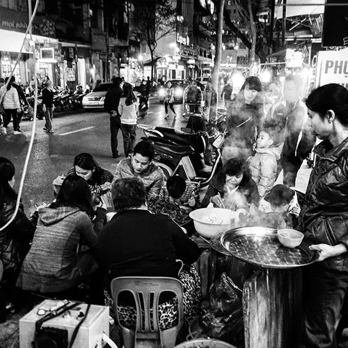 A scene of people enjoy street foods at night in old quar