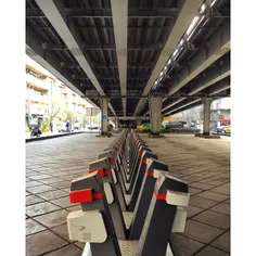 Bike parks with locks and meter, under the Karimkhan brid