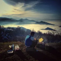 A man makes Kabab on a beautiful spot around ImamZadeh Ab