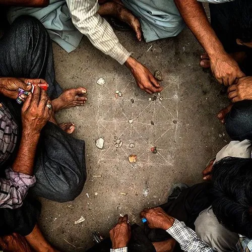 Indian men play a game on the streets of the old quarter 