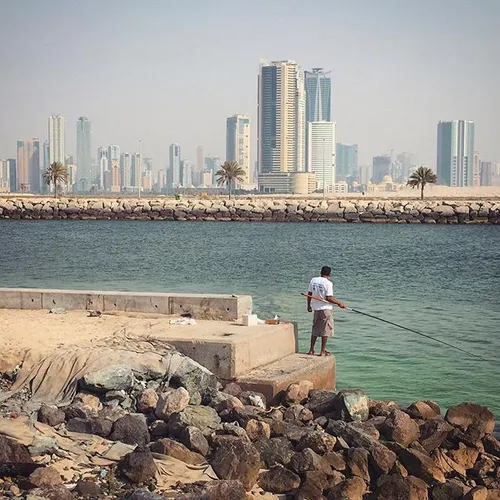 A fisherman waits for the catch of the day in Sharjah, UA