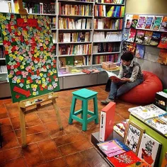 A boy reading a book at a bookshop. #Tehran, #Iran. Photo