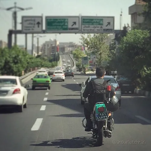 A police officer on the motorway has hooked his helmet of