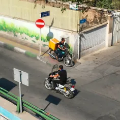 Motorcycle driving on the sidewalk، the opposite directio