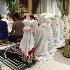 A Saudi family praying together, Jeddah, Saudi Arabia. Ph