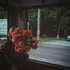 Woman holding flowers in a trolley. Chisinau. Moldova 