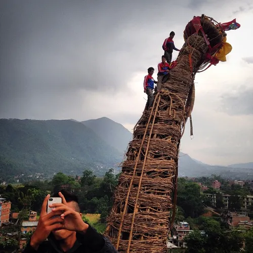 A Nepalese boy takes a selfie as devotees climb the chari
