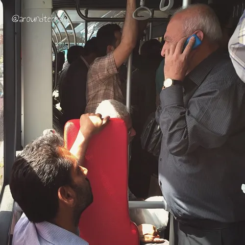 Curious seated passenger on the bus. There should apparen