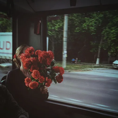 Woman holding flowers in a trolley. Chisinau. Moldova