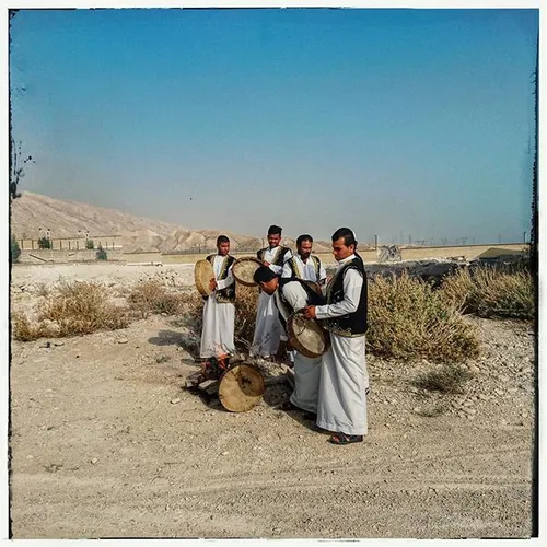 An Arabic music group preparing their instruments before 