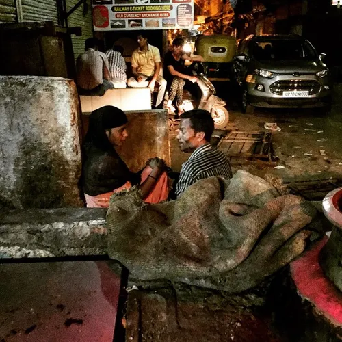 An Indian couple sits and talk in the middle of the night