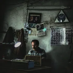 A TV and radio repairman works at his shop. #Mazandaran, 