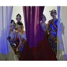 Javanese dancers waiting offstage watch a performance at 