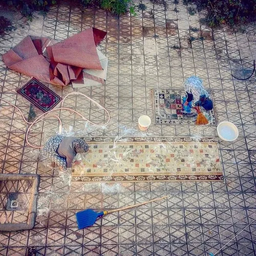 Women scrubbing carpets at the house yard. Mashhad, Razav