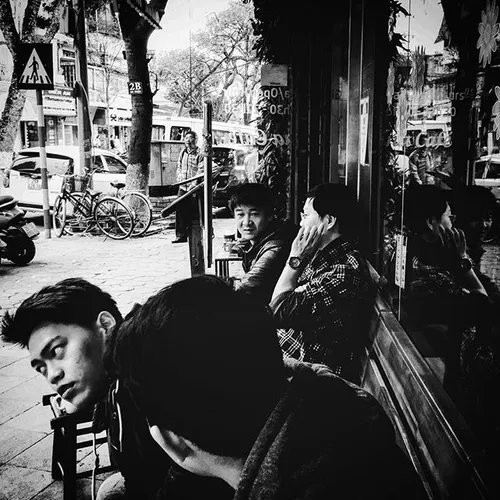 Men having coffee and chitchat at a street cafe in old qu