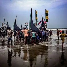 Rohingya fishermen push a boat up to shore near the Shamp